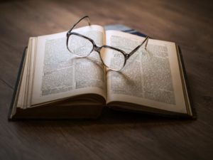 A book with a pair of glasses on