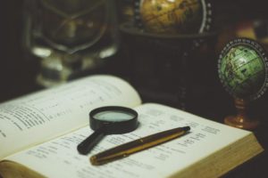 Magnifying glass and a book